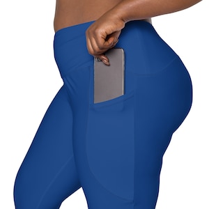 May include: Royal blue leggings with a large pocket on the right side, a cell phone is tucked into the pocket.