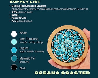 May include: A wooden coaster with a blue, turquoise, and white mandala design. The coaster is painted with dots and has the text "OCEANA COASTER" below it.