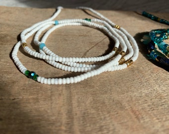 White seed bead waist bead with green and gold accents