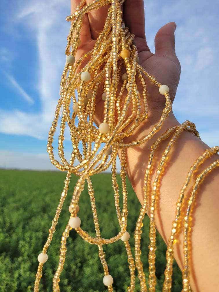 Gold waist bead chains with crystal accents.