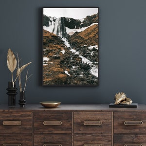 May include: A framed photograph of a waterfall cascading down a rocky mountainside. The image is in black and white and features a dramatic landscape.