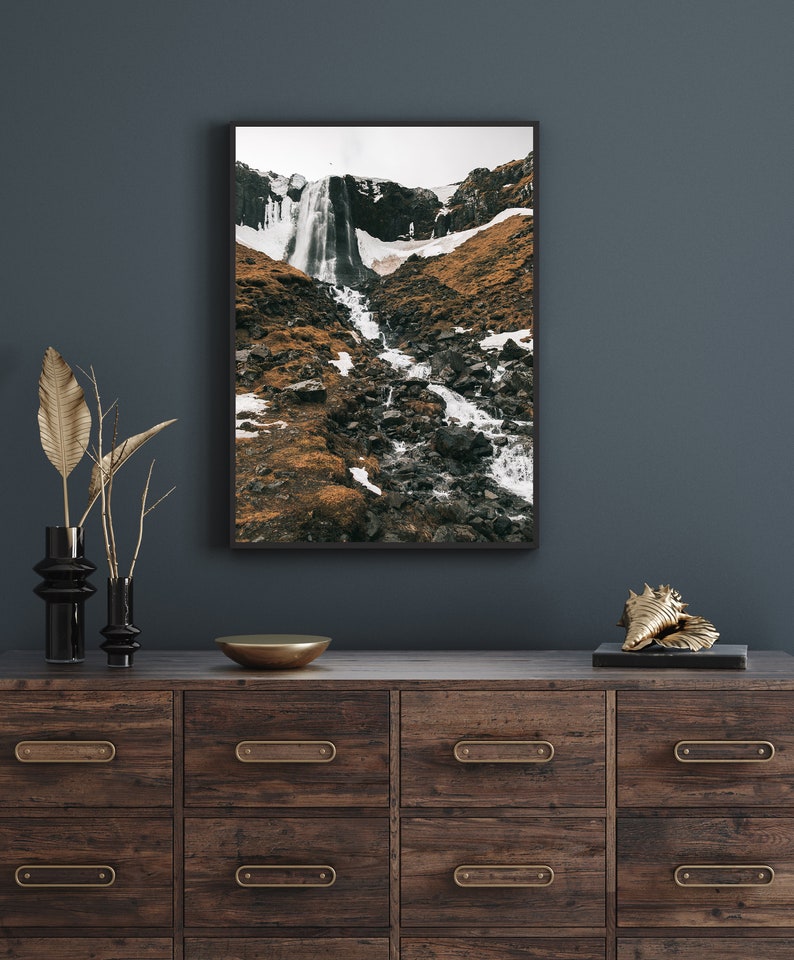 May include: A framed photograph of a waterfall cascading down a rocky mountainside. The image is in black and white and features a dramatic landscape.