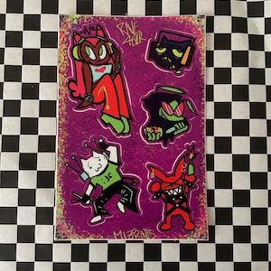 May include: A sticker sheet with cartoon characters on a purple background. The characters include a cat with antennae, a red devil-like figure, and other stylized figures. The text "Rave Fever" and ":3C" are visible.