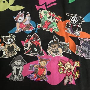 May include: A set of ten colorful stickers featuring cartoon characters in various poses. The stickers are printed on a clear background and have a glossy finish.