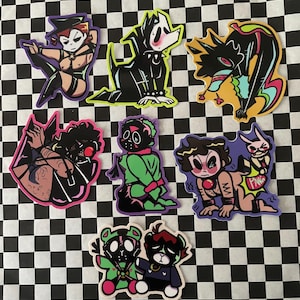 May include: A collection of colorful stickers featuring cartoon characters in various poses. The stickers have a black outline and are on a black and white checkered background. The characters have a variety of expressions and outfits.