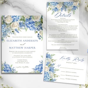 May include: Wedding invitation suite featuring elegant floral designs in shades of blue and white. The set includes an invitation, details card, and RSVP card. The text includes the names of the couple, date, time, and location of the wedding.