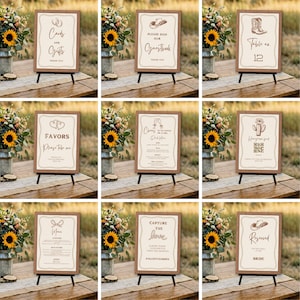 May include: A collection of nine rectangular wedding signs with brown frames, each featuring unique text and illustrations like cowboy boots, hats, and cacti, displayed on small black easels with a cream background and brown decorative borders.