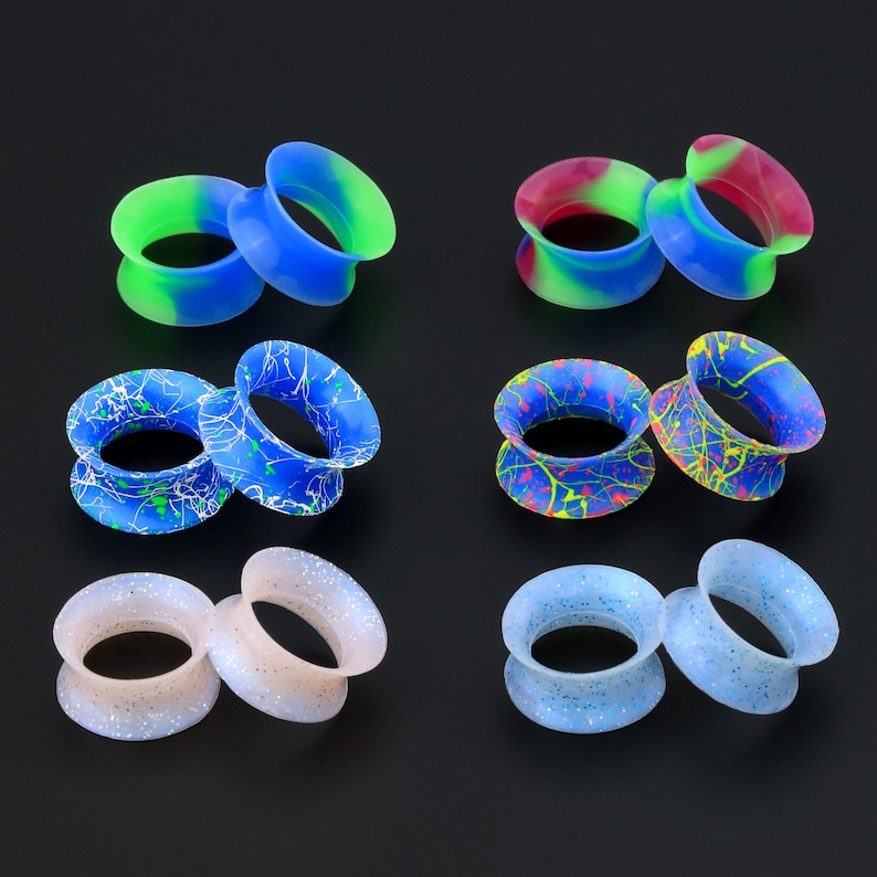 May include: Set of 10 silicone ear gauges in various colors and patterns, including blue, green, pink, white, and black. The gauges are made of flexible silicone and are designed to stretch the earlobe.