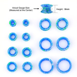 May include: Set of 10 blue and green acrylic ear gauges with white speckles. The gauges are in various sizes and are 8 mm in height. Actual gauge size is measured at the center.