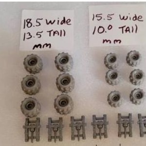 May include: A set of 10 gray plastic wheels with a 18.5 inch width and 13.5 inch tall measurement. The wheels are arranged in two rows of five. There are also 7 gray plastic axles with a 15.5 inch width and 10.0 inch tall measurement. The axles are arranged in a row of seven.