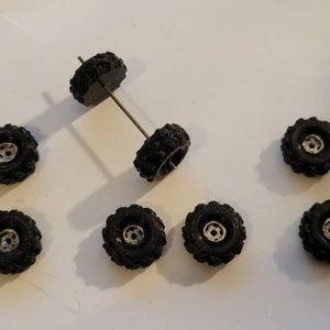 Mud Grip Tires with hand painted chrome center For 1/64 scale cars. Black 3d printed. 12 items altogether.