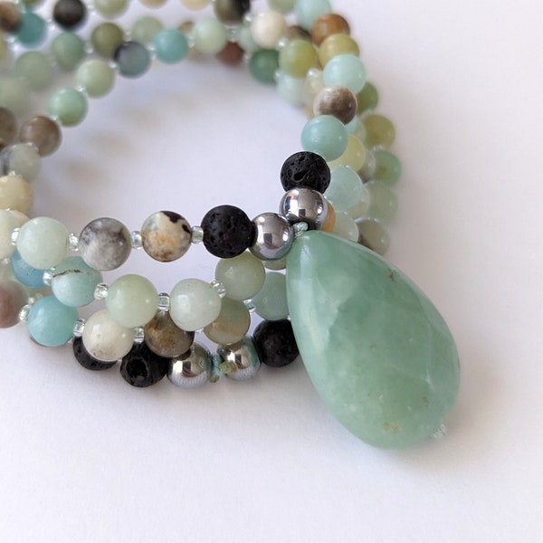 Caribbean Calcite Gemstone Beaded Necklace with Teardrop Pendant. Stunning Blue Gemstone Beads and Round Lava Beads.