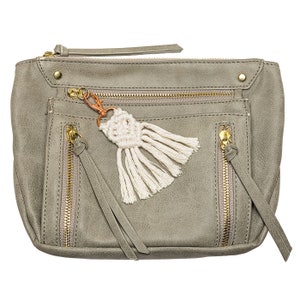 May include: A gray faux leather zippered pouch with a white tassel keychain. The pouch has multiple zippered compartments and a gold zipper.