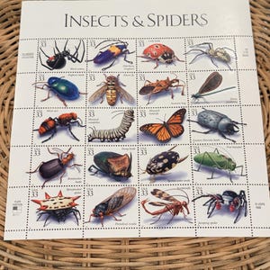 May include: A sheet of twenty 33-cent postage stamps titled Insects & Spiders, featuring detailed illustrations of various creatures including a black widow, lady beetle, monarch butterfly, and jumping spider, each labeled with its common name.