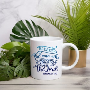 May include: White ceramic coffee mug with a blue and white design that reads "Blessed is the man who trusts the Lord" and "Jeremiah 17:7".