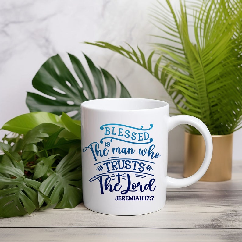 May include: White ceramic coffee mug with a blue and white design that reads "Blessed is the man who trusts the Lord" and "Jeremiah 17:7".