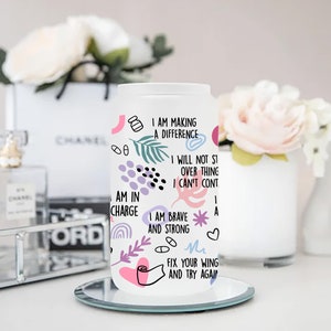 May include: White tumbler with a colorful design and inspirational quotes. The quotes include "I am making a difference", "I will not stop", "I am in charge", "I am brave and strong", and "Fix your wing and try again".