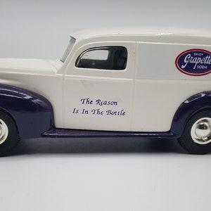 May include: White and purple vintage delivery van with the words "The Reason Is In The Bottle" and a logo for Grape-ette Soda.