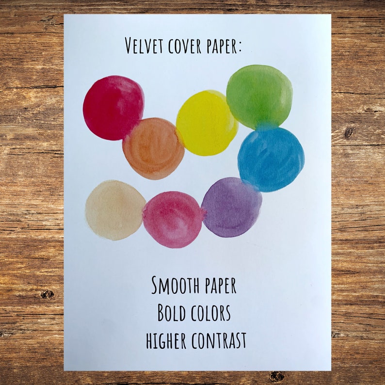 May include: A white card with the text "VELVET COVER PAPER: " and a row of seven colorful circles in a rainbow pattern. The text below the circles reads "SMOOTH PAPER", "BOLD COLORS", and "HIGHER CONTRAST".