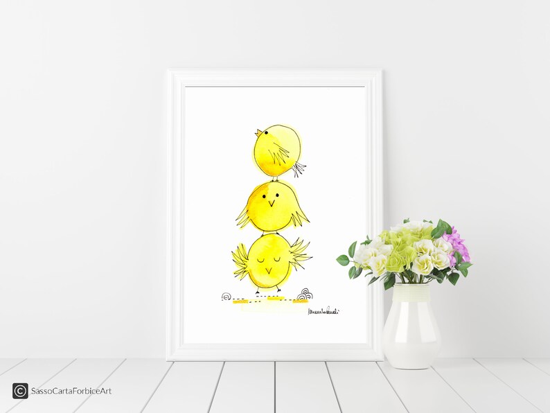 May include: A watercolor painting of three yellow chicks stacked on top of each other. The chicks are drawn in a simple, cartoon style with black outlines. The background is white.