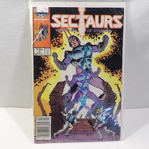May include: A comic book titled "Sectaurs Warriors of Symbion" featuring a group of insect-like warriors in a battle scene. The cover art is vibrant with purple, blue, and yellow hues. The comic is in a plastic sleeve.