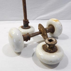 May include: A rustic wooden sign with the text "Welcome to our home" in white lettering. The sign features a distressed finish and a simple, inviting design, perfect for entryway decor.