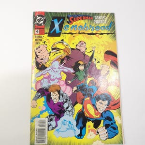 May include: Comic book cover featuring Superman and other characters. The title "Superman Takes Charge Xenobrood" is displayed. The cover art is vibrant with a yellow and green background, and the characters are in dynamic poses.