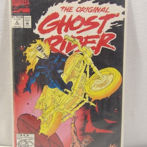 May include: A comic book cover featuring the Ghost Rider, a flaming skeleton riding a motorcycle, with the text "The Original Ghost Rider" in red and black. The cover also features a 30th Anniversary logo and the text "The Amazing Spider-Man".