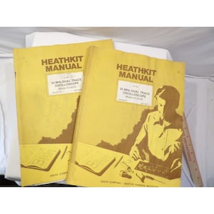 Op de afbeelding: Twee vintage Heathkit-handleidingen met gele covers. De tekst op de cover luidt "HEATHKIT MANUAL" en "35 MHz DUAL TRACE OSCILLOSCOPE Model IO-4235". Eén handleiding bevat een illustratie van een persoon die aan elektronica werkt. De handleidingen zijn waarschijnlijk voor elektronica-enthousiastelingen.