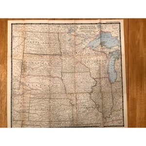 May include: A vintage map of the North Central United States from The National Geographic Magazine. The map features detailed geographical information, including state boundaries, cities, and bodies of water. The map is printed on aged paper.