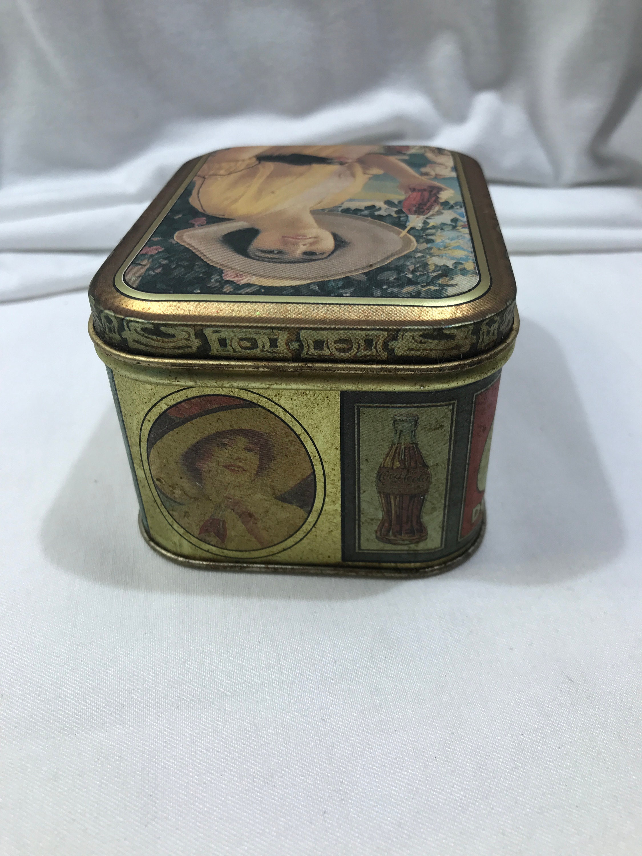 gold and brown lady with hat design Bristol Ware 1984 collectible rectangle tin box Coca Cola collectible tin