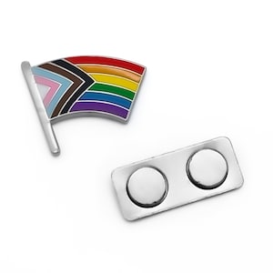 May include: A rainbow pride flag pin with a magnetic backing. The flag features the colors of the traditional rainbow flag, as well as black, brown, light blue, and pink stripes.