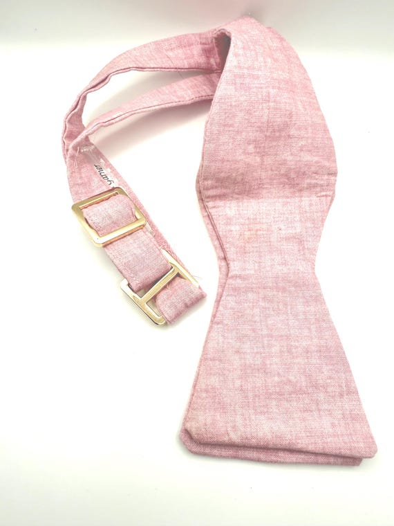 self tie bow tie. pink with gold hardware