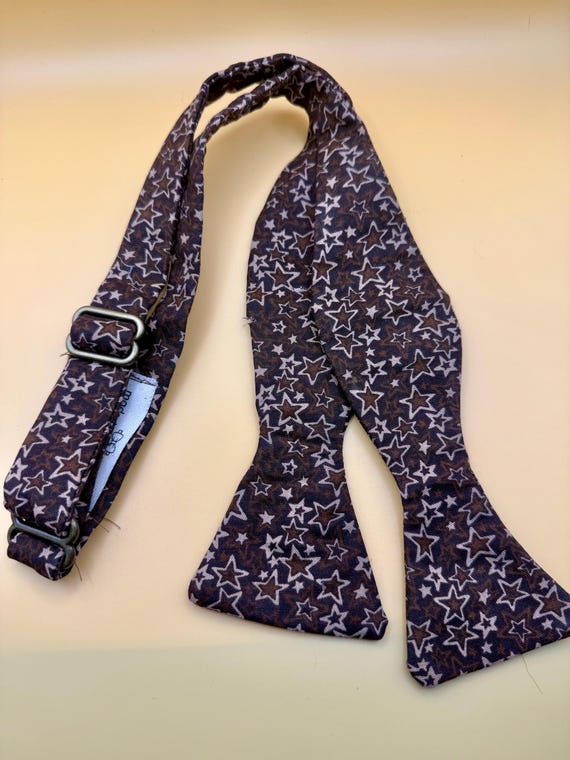 Brown with light brown stars self-tie      cotton bow tie with gold plated hardware