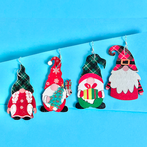 May include: Four pairs of Christmas gnome earrings. Each pair features a different gnome design with a red, green, and white plaid pattern. The gnomes are holding a Christmas tree, a gift, and a candy cane.
