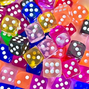 May include: A collection of colourful dice with white dots. The dice are made of clear plastic and have a variety of colours, including red, orange, yellow, green, blue, purple, and pink.