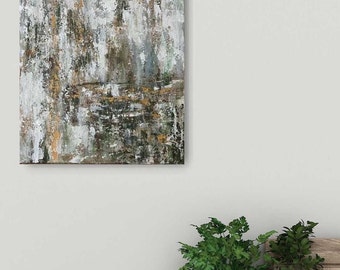 May include: Abstract painting with a textured, layered look. The painting features shades of white, gray, brown, and green. The painting is framed and ready to hang.