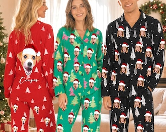 May include: Three sets of long-sleeved button-down pajamas featuring festive patterns. The red set displays a dog's face with a Santa hat and the name Cooper. The green and black sets feature repeating human faces wearing Santa hats and Christmas trees.