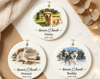 Pode incluir: Três ornamentos redondos de cerâmica branca com fotos de animais de estimação. Um mostra um golden retriever, um um gato cinzento e um um husky. Cada um inclui o texto "forever loved" com um coração, o nome e os anos 2008-2026.