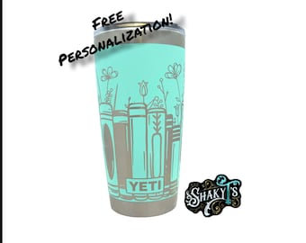 Diseño de libro floral de 20 oz - 360 grados, grabado a láser en un vaso Yeti con tapa magnética. Disponible en varios colores.