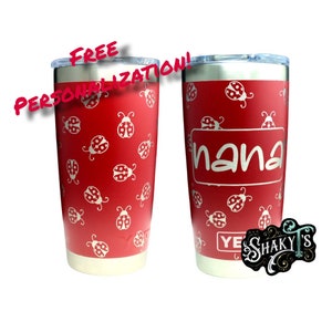 May include: Red stainless steel tumbler with a ladybug pattern and the word "nana" engraved on the front. The tumbler is 20 ounces and has a double-wall insulated design.