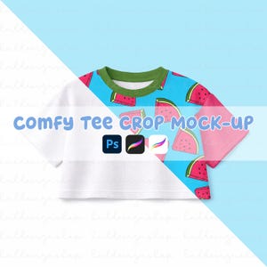 May include: A white crop top with a watermelon pattern on the sleeves and upper chest. The design features red watermelon slices on a light blue background, with a green collar. The text "COMFY TEE CROP MOCK-UP" is displayed.