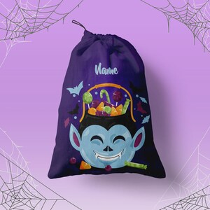 May include: A dark purple drawstring bag featuring a graphic of a light blue vampire face holding a yellow cauldron filled with colorful candies. The word Name is printed in light blue script above the vampire illustration, surrounded by small bats.