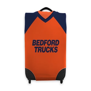May include: Orange and navy blue luggage cover with the text "BEDFORD TRUCKS" printed on the front.