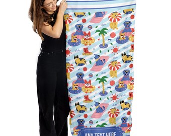 May include: A blue and white beach towel with a repeating pattern of dogs wearing sunglasses and floaties. The towel has a blue stripe border and the text "ANY TEXT HERE" in a blue banner at the bottom.