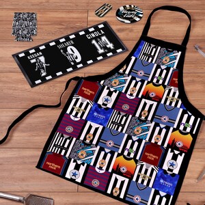 May include: A black apron with a patchwork design of soccer jerseys in various colors, including black and white stripes, blue, and red. A black and white rectangular mat with player names and numbers is also visible, along with coasters and a can cooler.