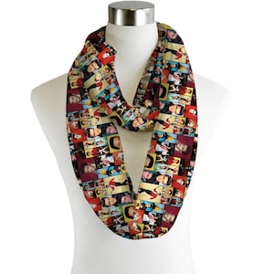 May include: A black infinity scarf featuring a colourful pattern of Elvis Presley's face in various poses. The scarf is made from a soft, comfortable fabric and is ideal for adding a touch of personality to any outfit.