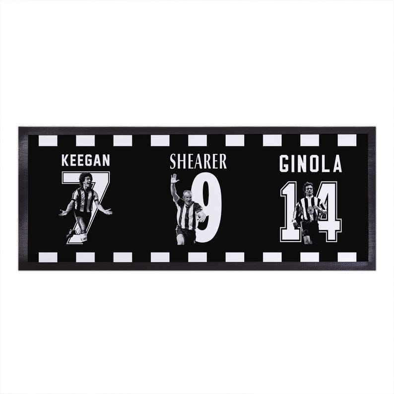 May include: Black and white framed print featuring three soccer players: Keegan, Shearer, and Ginola. Each player is depicted in action with their jersey number prominently displayed. The frame has a black and white checkered border.