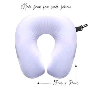 May include: A light purple travel neck pillow made from faux suede fabric. The pillow measures 35 inches by 37 inches.