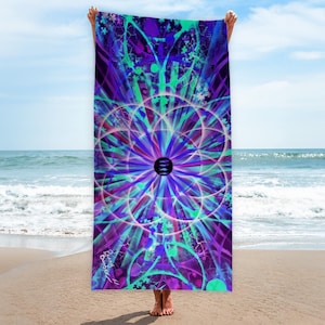 Könnte beinhalten: Ein lebendiges Strandtuch mit psychedelischem Design. Das Tuch zeigt ein zentrales kreisförmiges Muster in Lila, Blau und Grün mit radialen Linien und geometrischen Formen. Der Hintergrund ist eine Mischung aus ähnlichen Farben. Das Tuch wird an einem Strand gehalten.